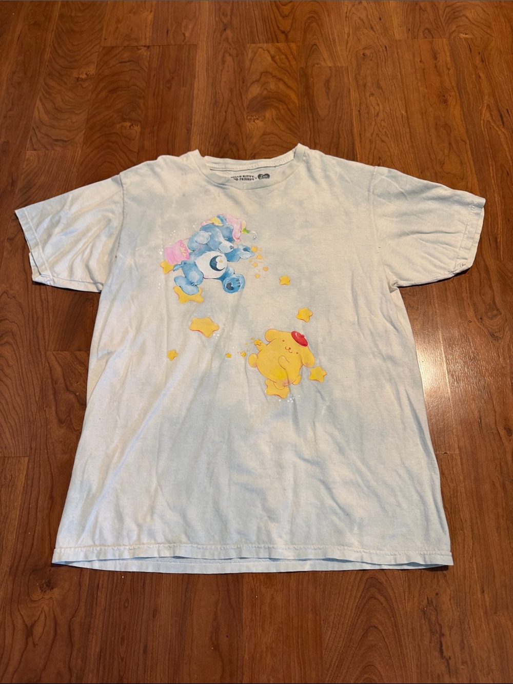 Care Bears Short Sleeve Tee in Pale Blue with Yellow Graphic